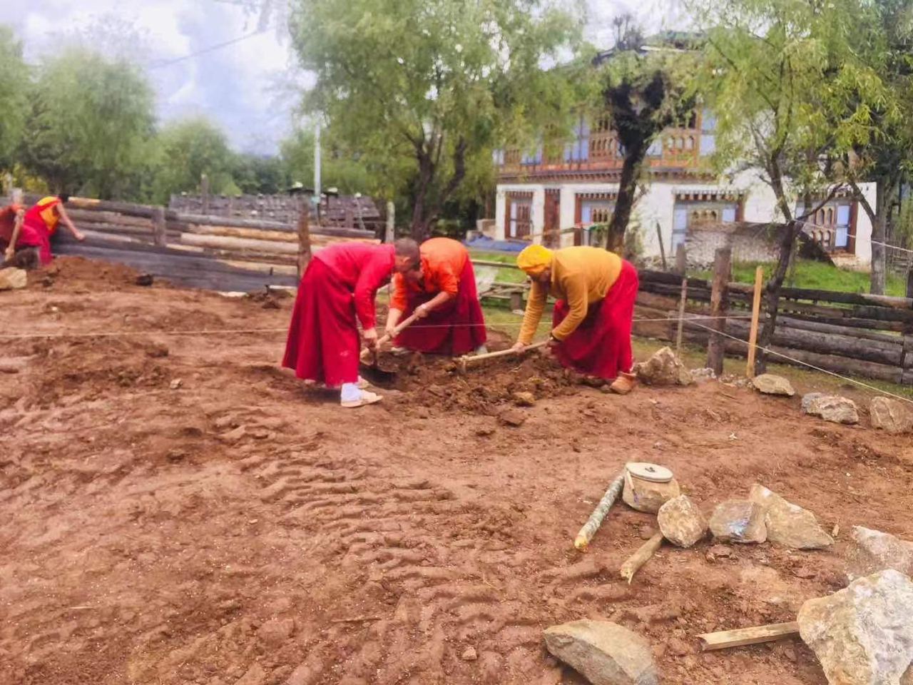 Rinpoche and monks building new dormitory